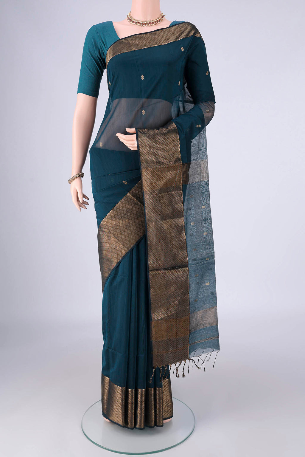 Dark Blue Maheshwari Silk Cotton Saree with Zari Butta on the body and Zari Border.  displayed on a mannequin