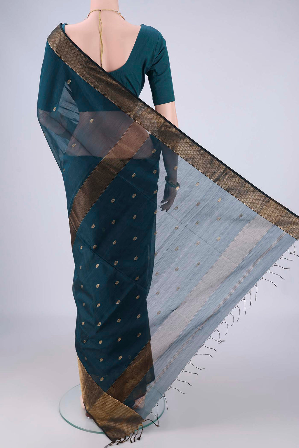 Flat view of Dark Blue Maheshwari Silk Cotton Saree with Zari Butta on the body and Zari Border. 