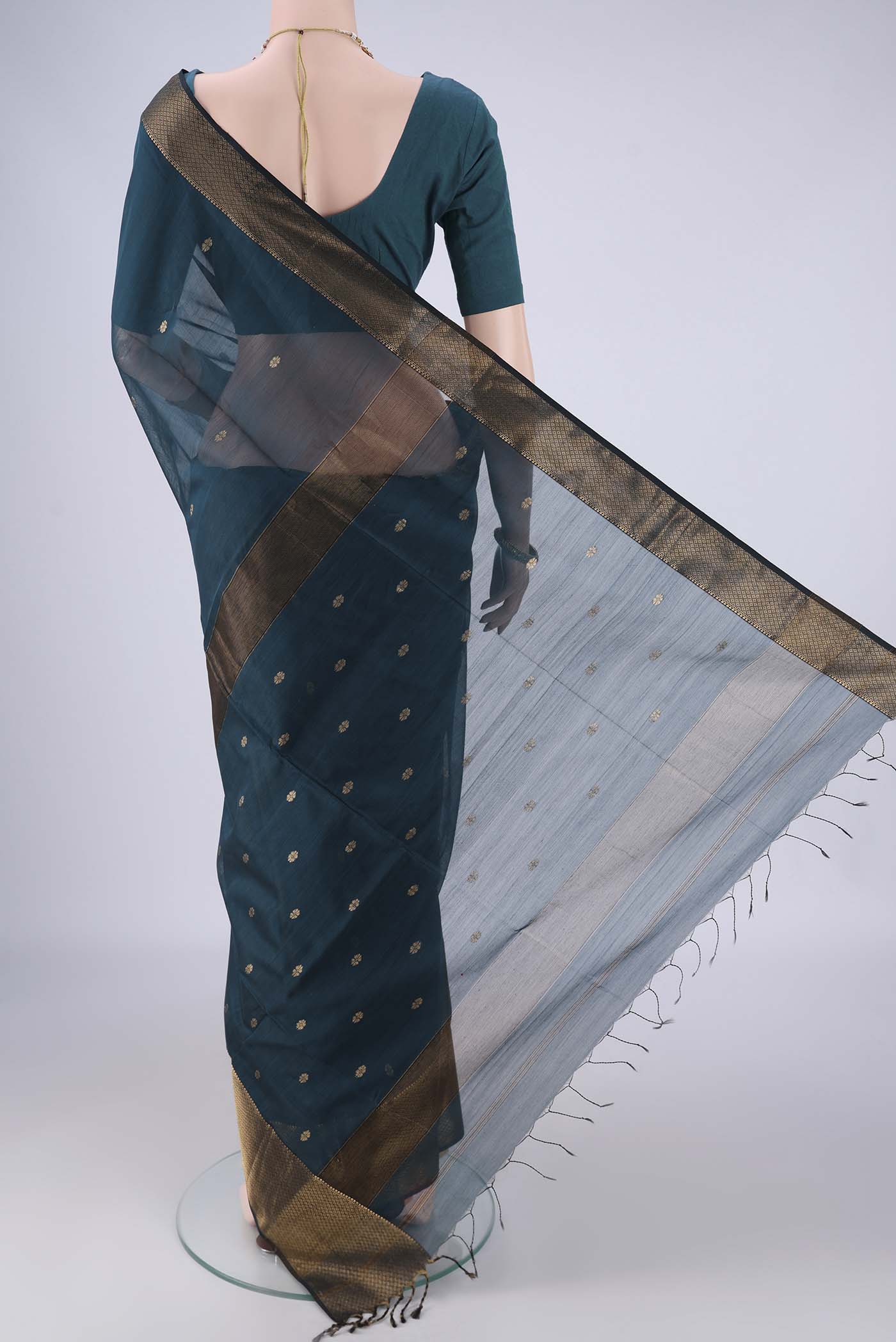 Flat view of Dark Blue Maheshwari Silk Cotton Saree with Zari Butta on the body and Zari Border. 