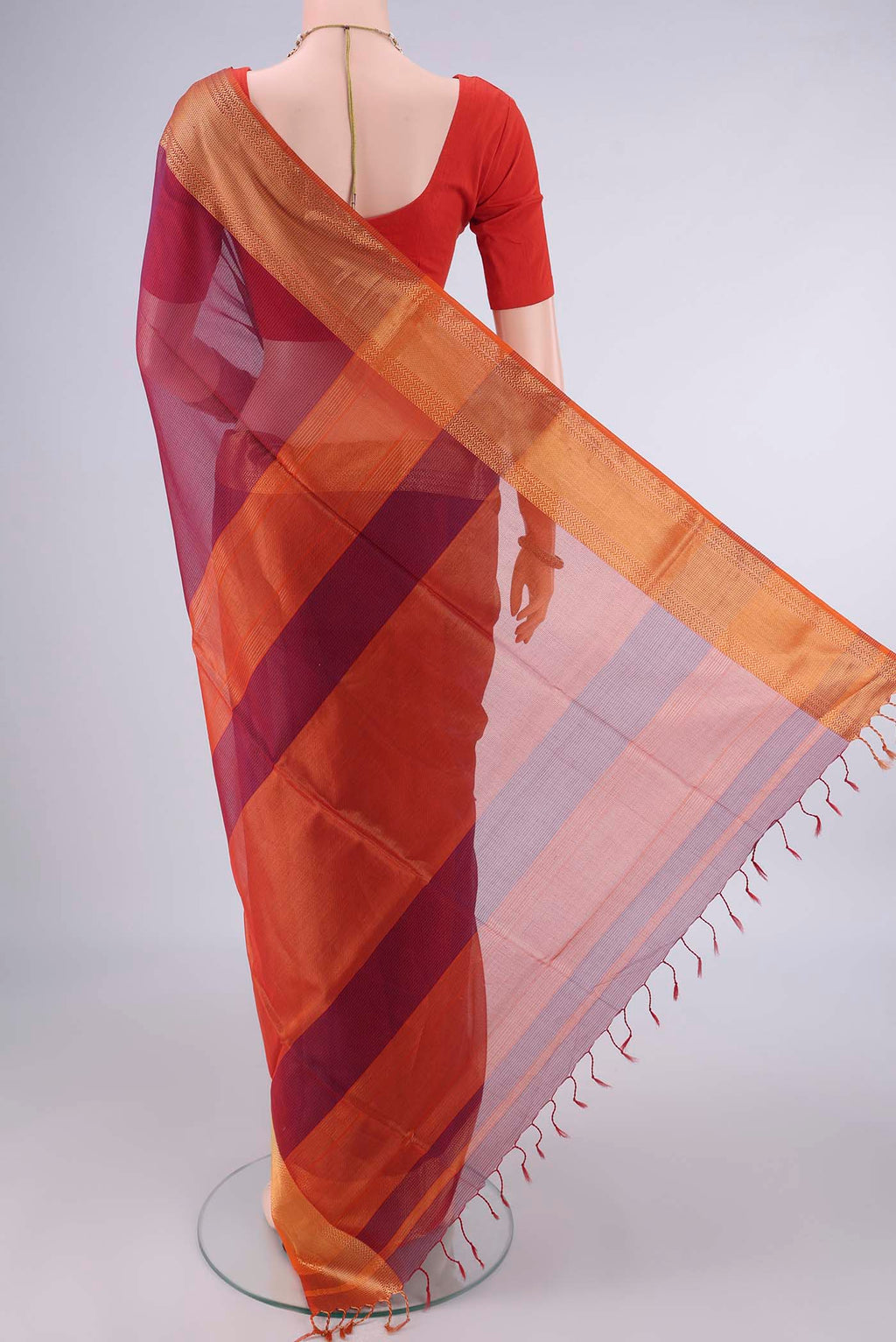 Flat view of Maroon Maheshwari Cotton Saree with Stripes on the body and Zari Border. 