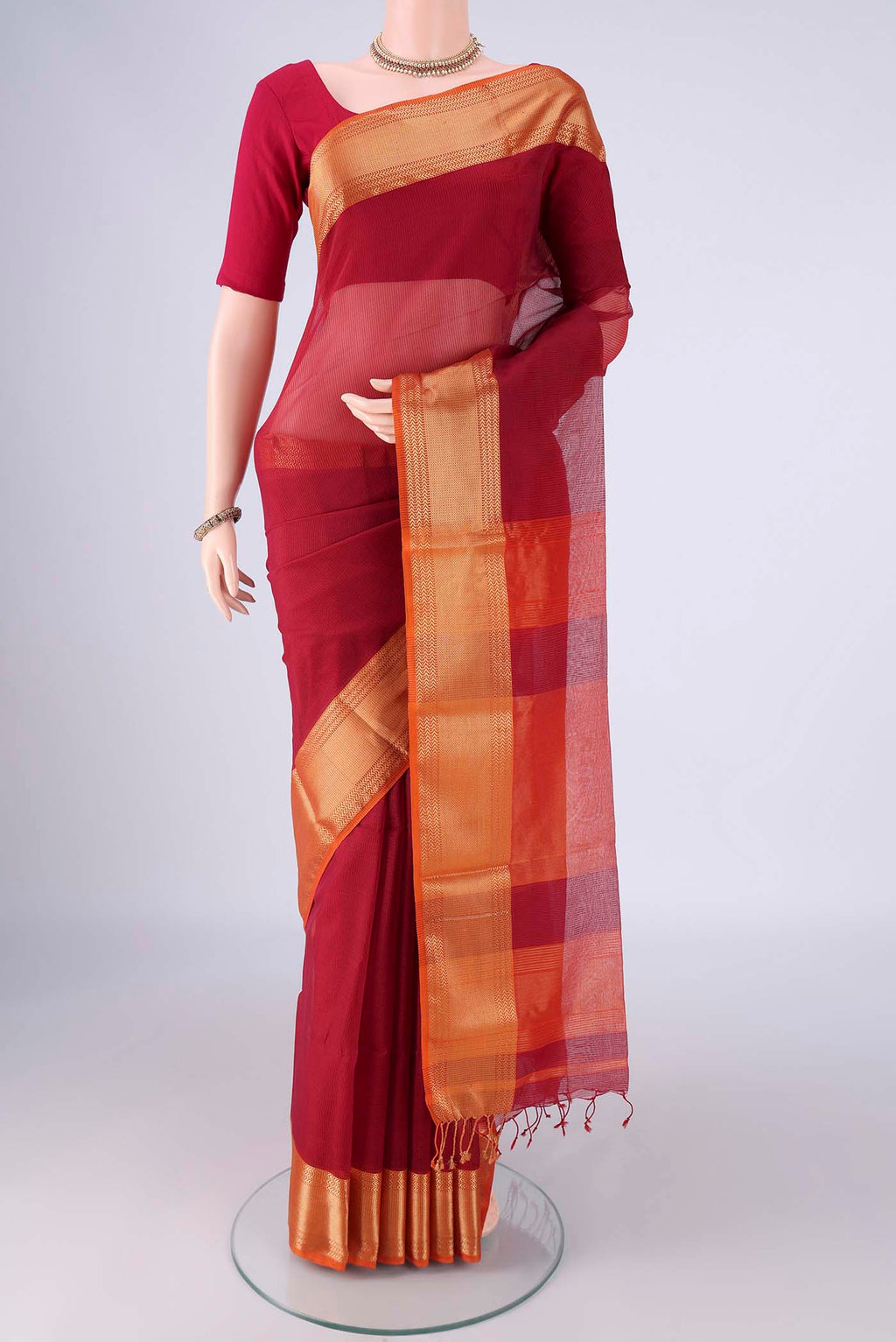 Red Maheshwari Silk Cotton Saree with Checked design on the body and Zari Border.  displayed on a mannequin