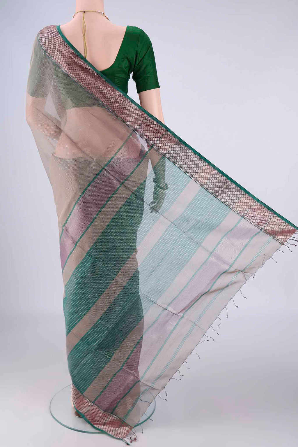 Flat view of Grey Maheshwari Silk Cotton Saree with Stripes on the body and Zari Border. 
