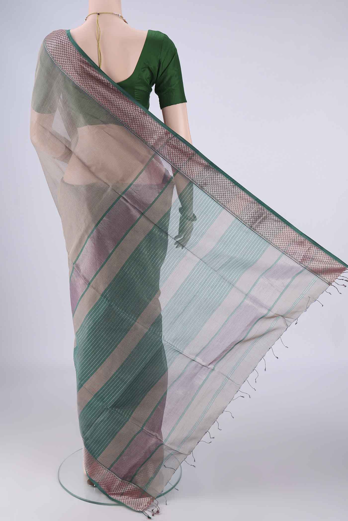 Flat view of Grey Maheshwari Silk Cotton Saree with Stripes on the body and Zari Border. 