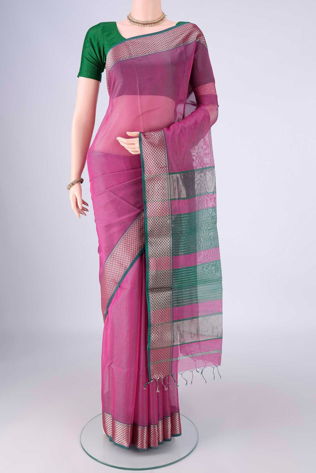 Magenta Maheshwari Silk Cotton Saree with Stripes on the body and Zari Border.  displayed on a mannequin