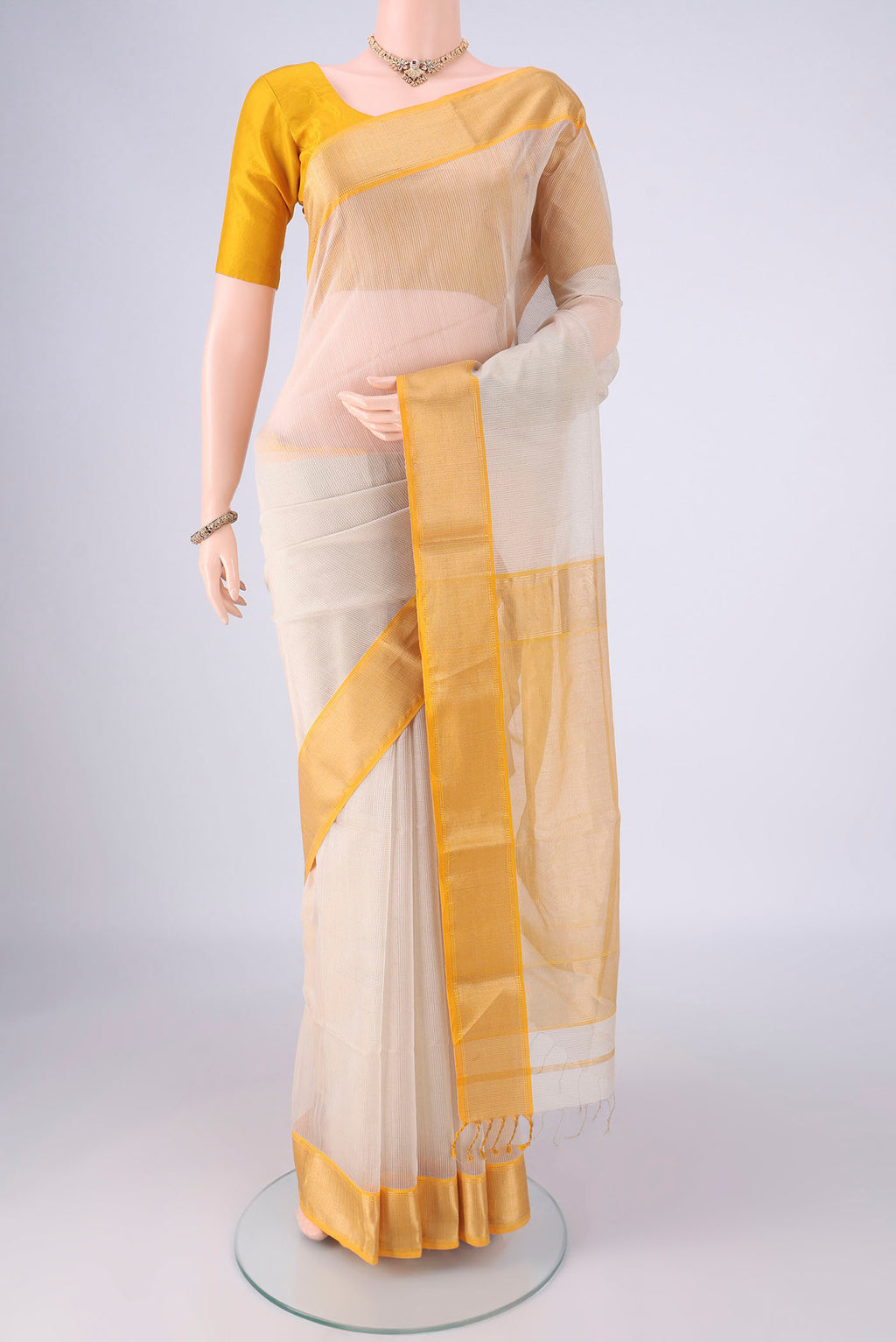 Off White Maheshwari Silk Cotton Saree with Stripes on the body and Zari Border.  displayed on a mannequin