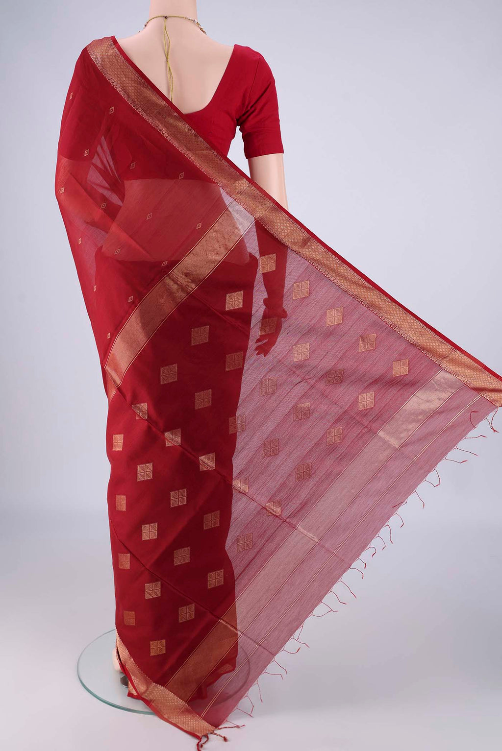 Flat view of Maroon Maheshwari Silk Cotton Saree with Zari Butta on the body and Zari Border. 