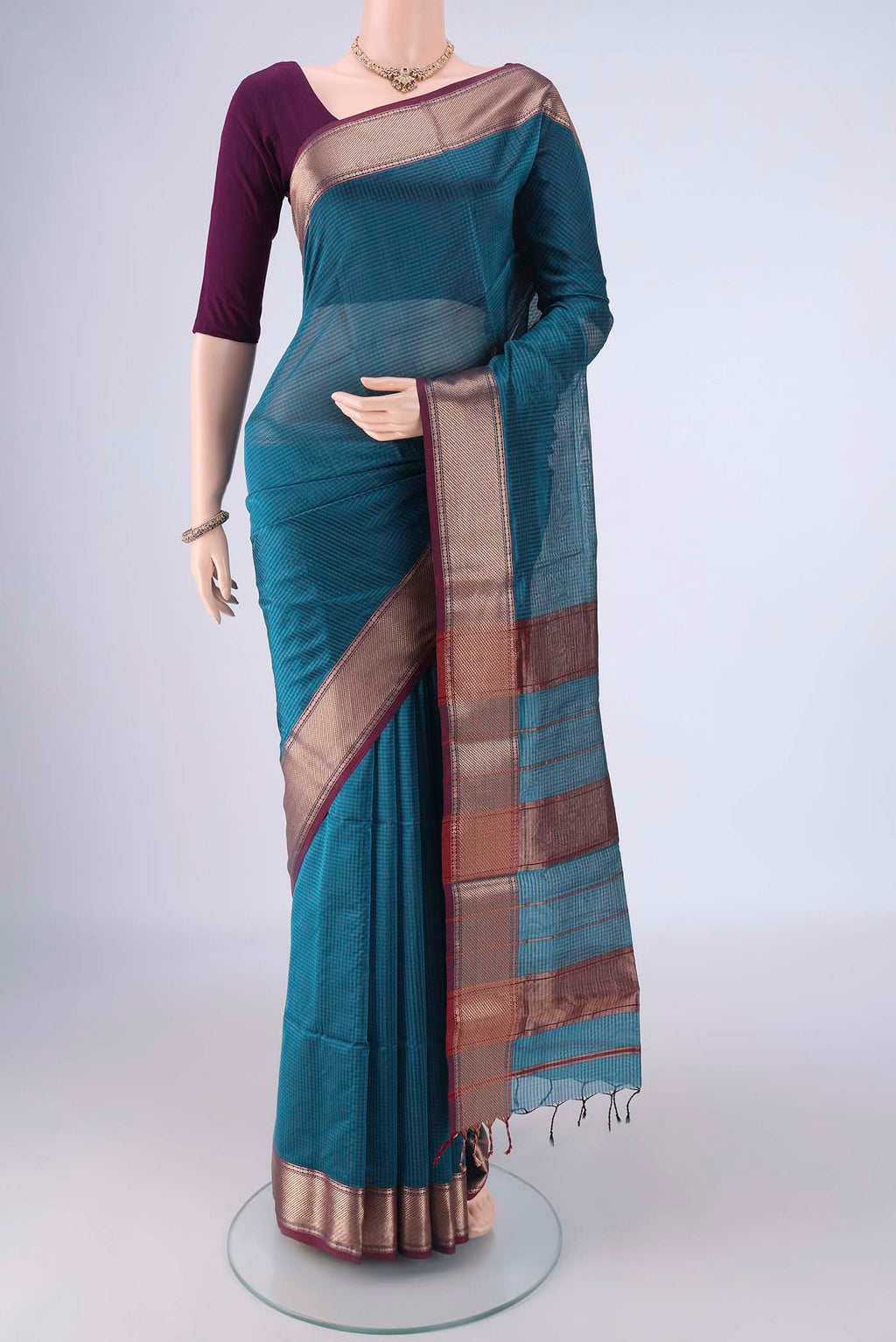 Teal Maheshwari Silk Cotton Saree with Checked design on the body and Zari Border.  displayed on a mannequin