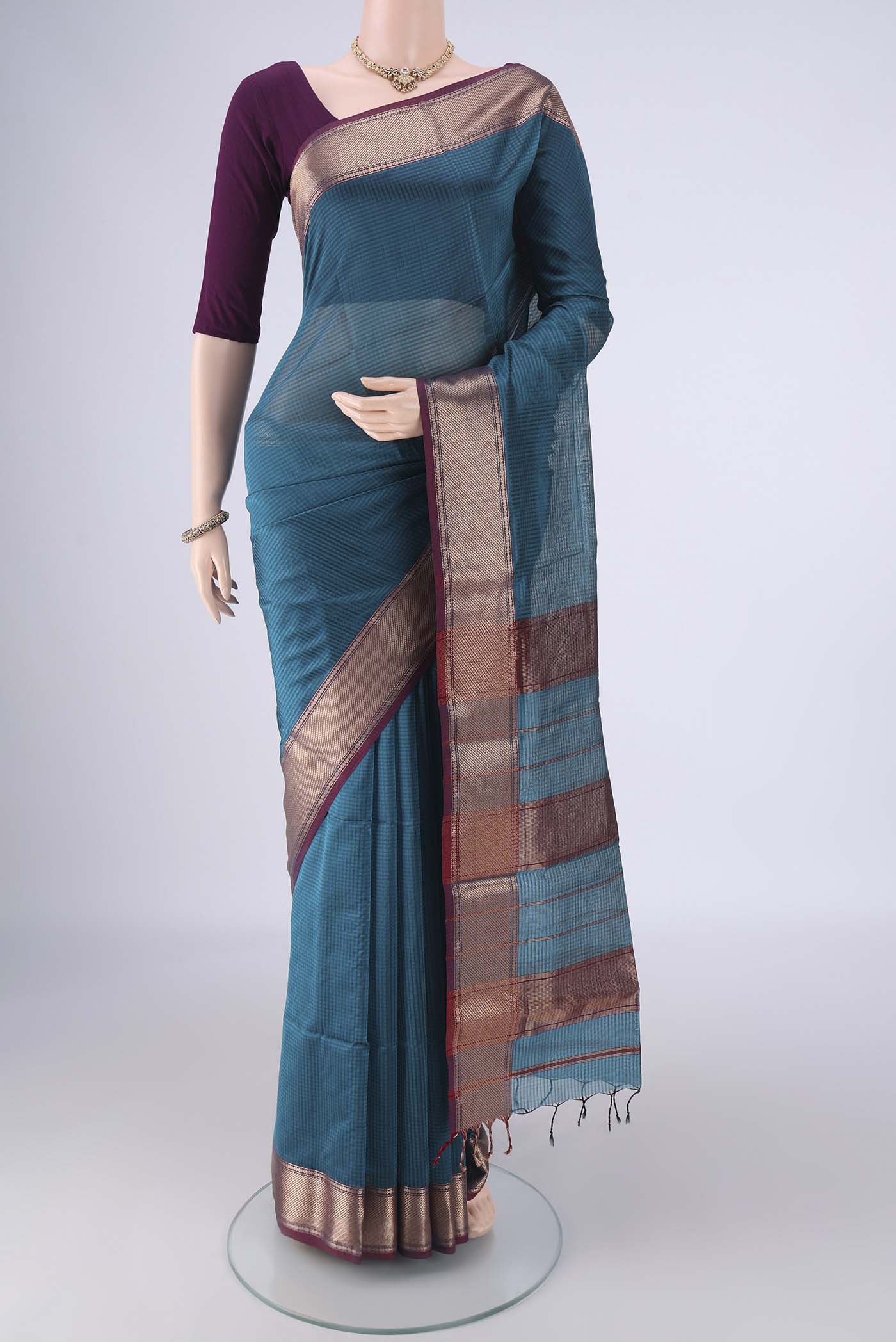 Teal Maheshwari Silk Cotton Saree with Checked design on the body and Zari Border.  displayed on a mannequin