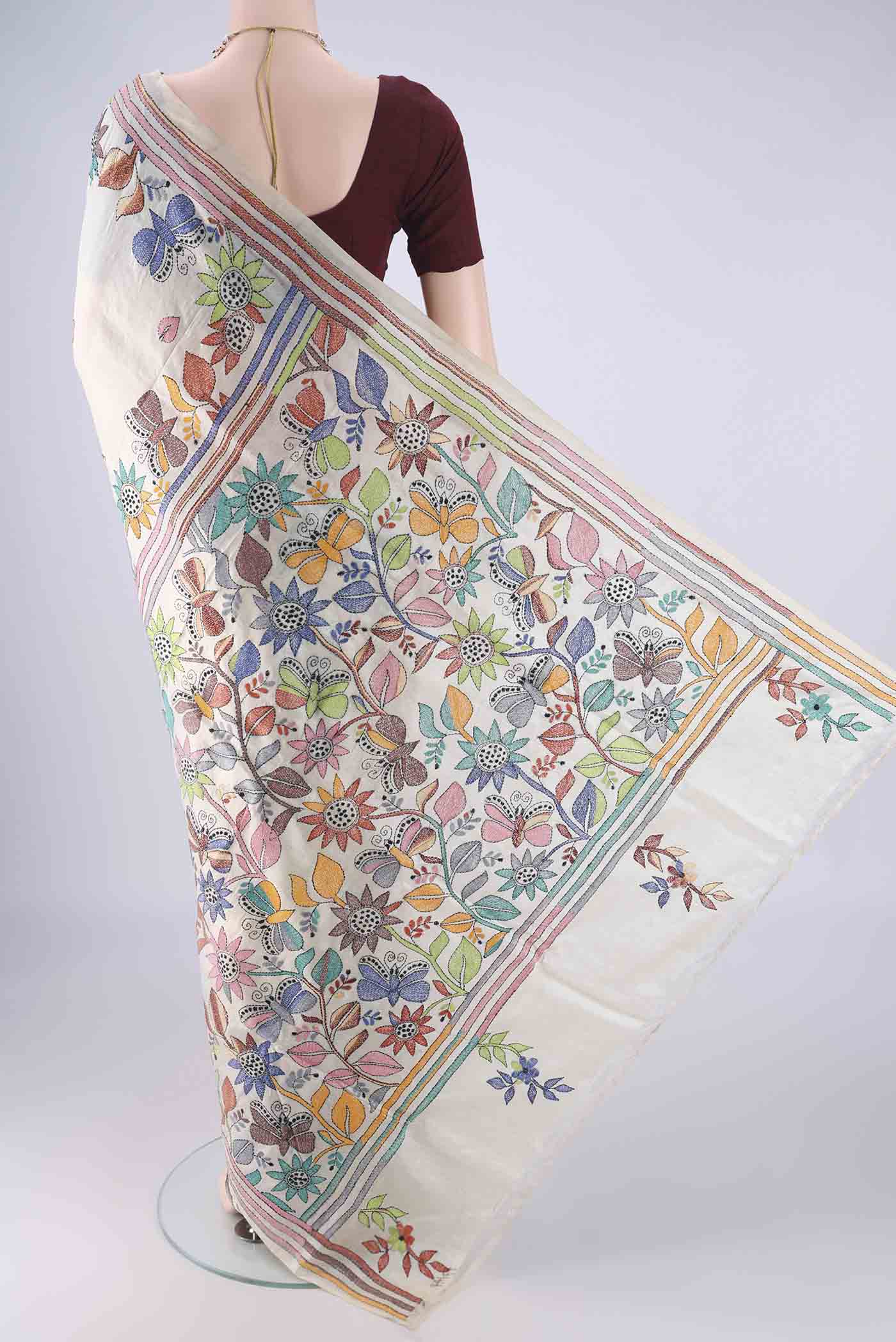 Flat view of Beige Tussar Silk Saree with Kantha Work on the body and Thread Border. 