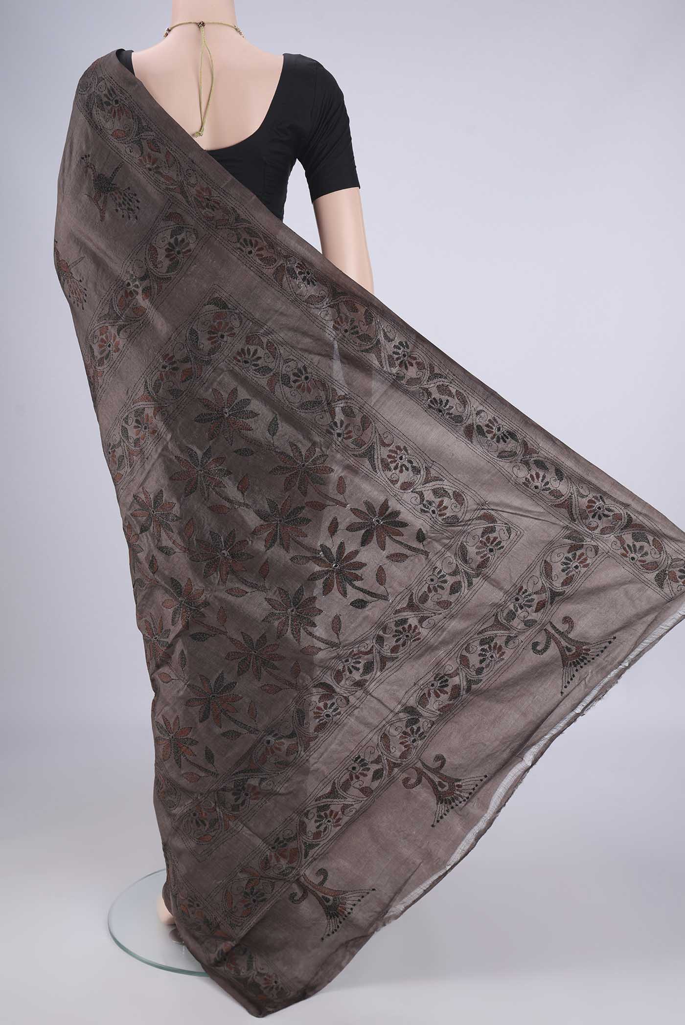 Flat view of Coffee Brown Tussar Silk Saree with Kantha Work on the body and Thread Border. 