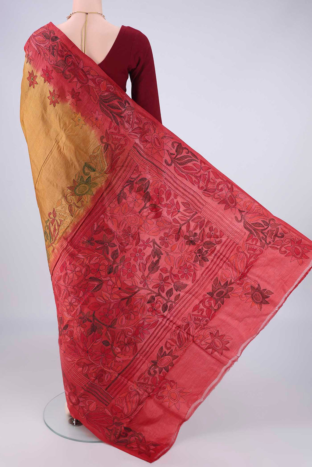 Flat view of Golden Tussar Silk Saree with Kantha Work on the body and Thread Border. 