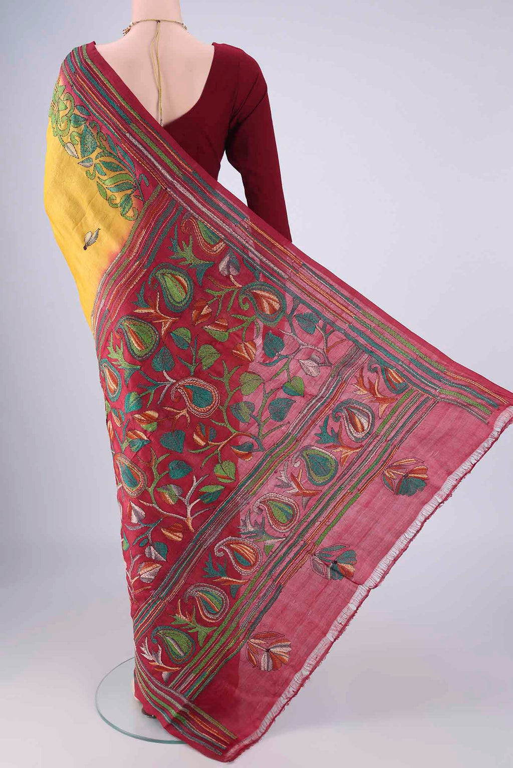 Flat view of Yellow Tussar Silk Saree with Kantha Work on the body and Thread Border. 
