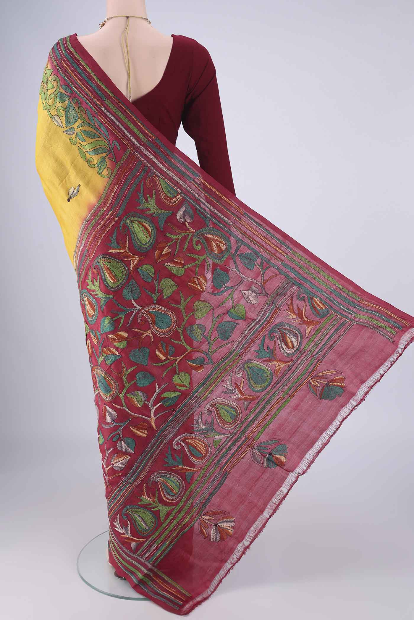 Flat view of Yellow Tussar Silk Saree with Kantha Work on the body and Thread Border. 