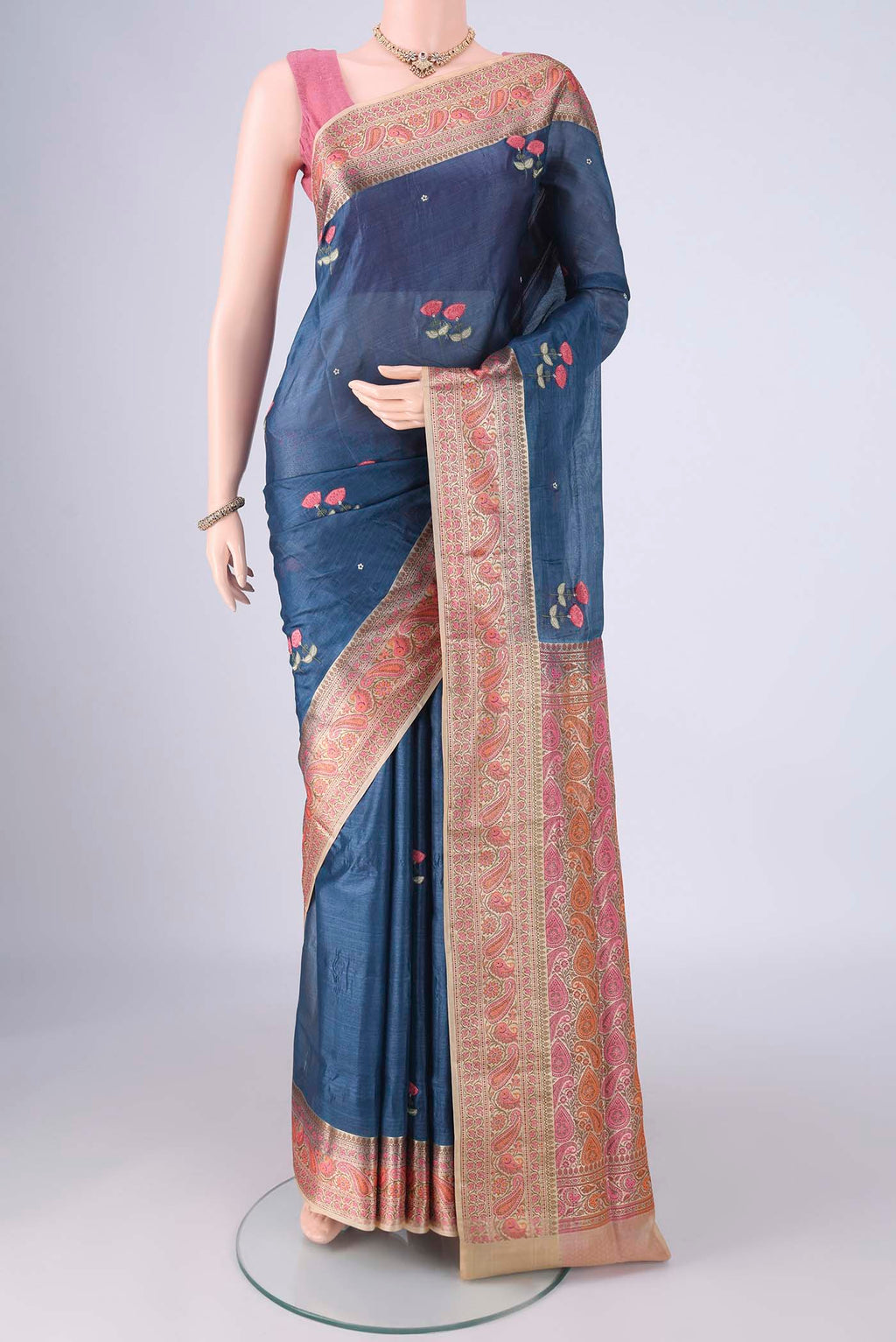 Blue Banarasi Tussar Silk Saree with Embroidery on the body and Zari Border.  displayed on a mannequin