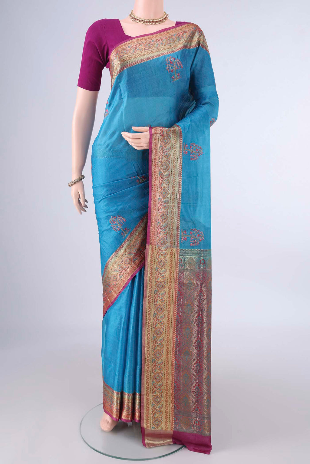 Blue Banarasi Tussar Saree with Embroidery on the body and Zari Border.  displayed on a mannequin