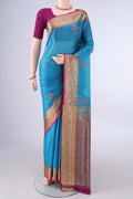 Blue Banarasi Tussar Saree with Embroidery on the body and Zari Border.  displayed on a mannequin
