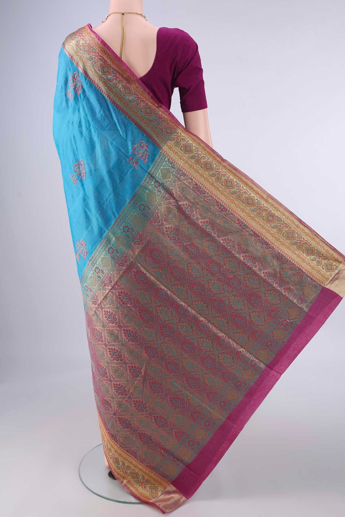 Flat view of Blue Banarasi Tussar Saree with Embroidery on the body and Zari Border. 