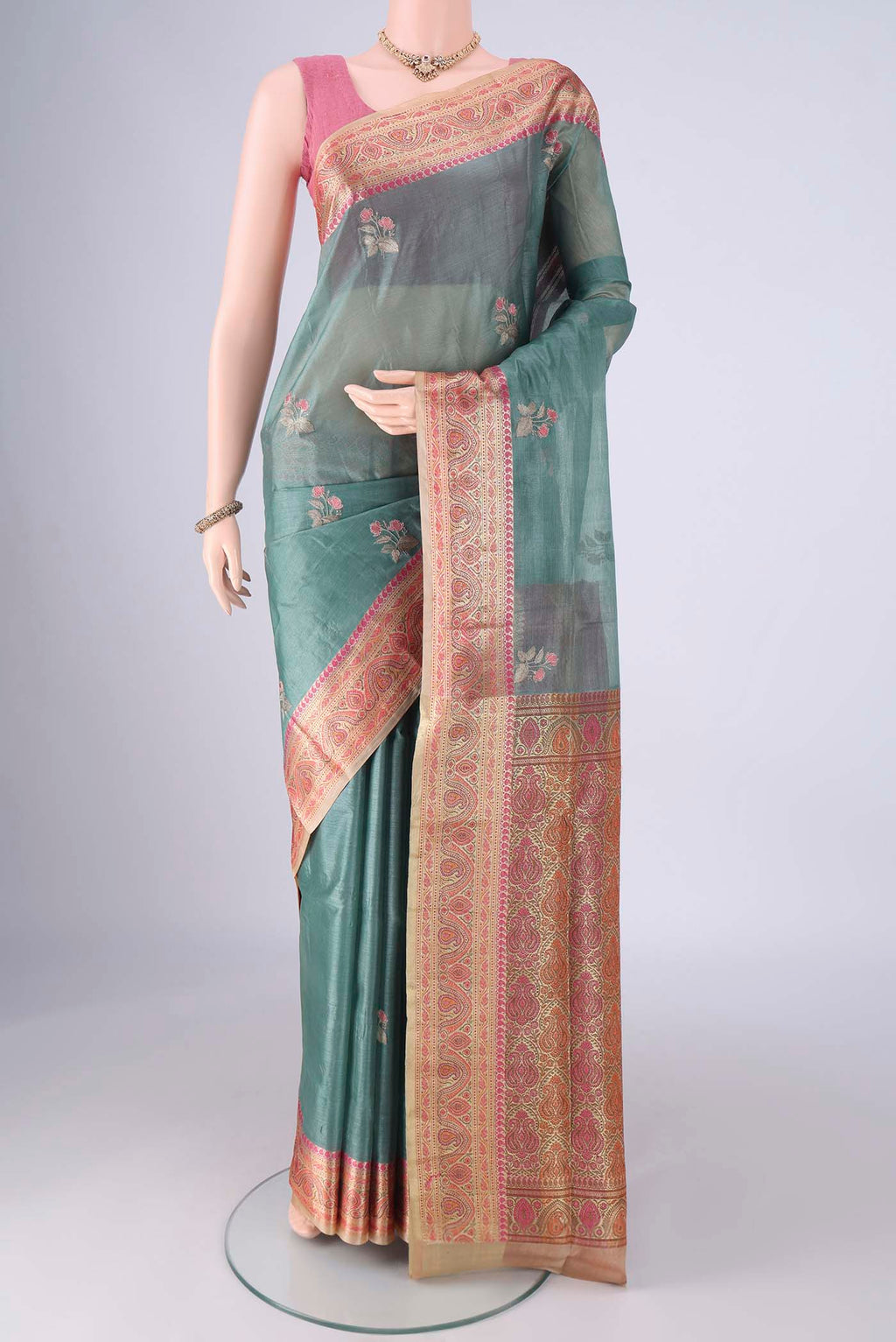 Light Green Banarasi Tussar Silk Saree with Embroidery on the body and Zari Border.  displayed on a mannequin