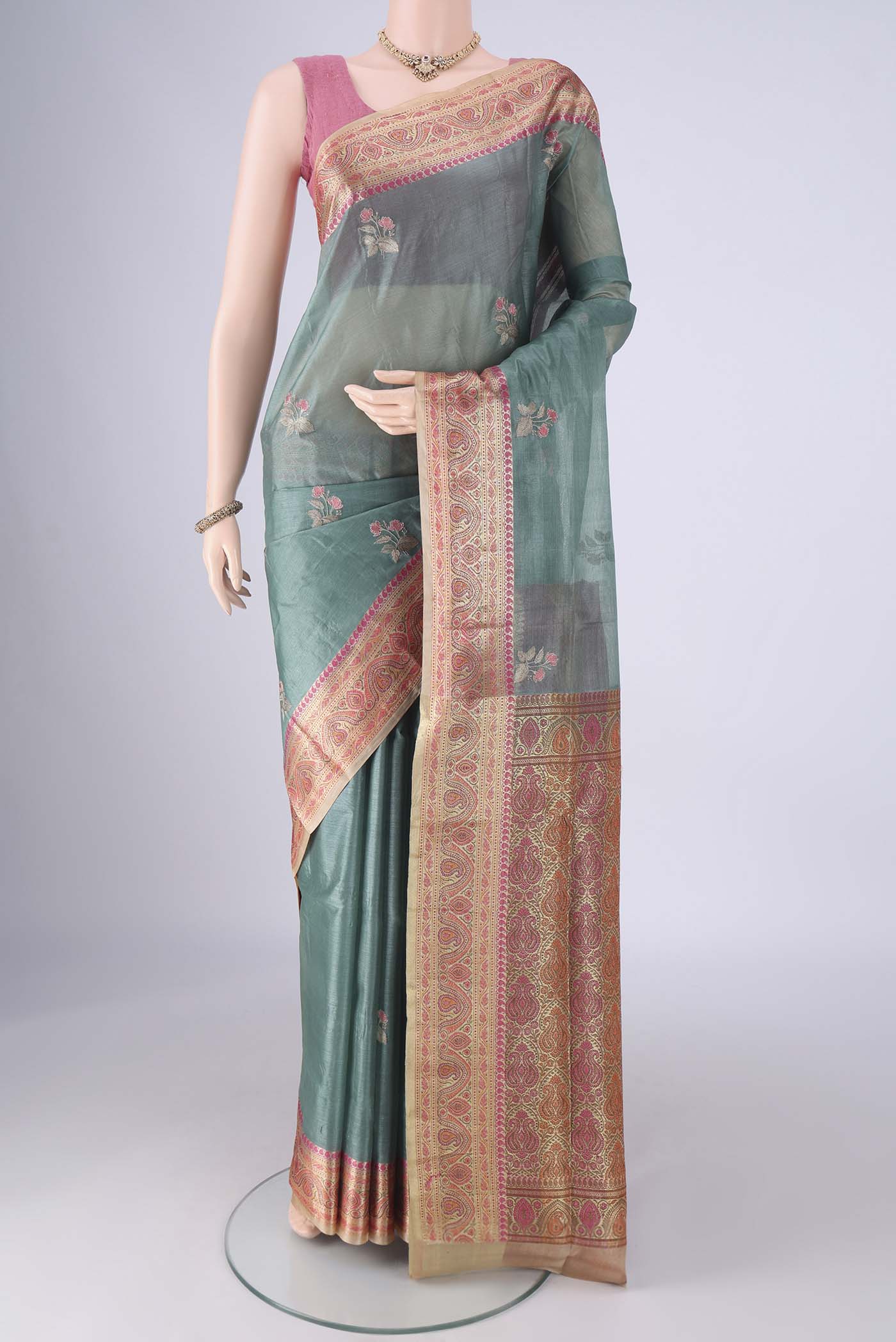 Light Green Banarasi Tussar Silk Saree with Embroidery on the body and Zari Border.  displayed on a mannequin