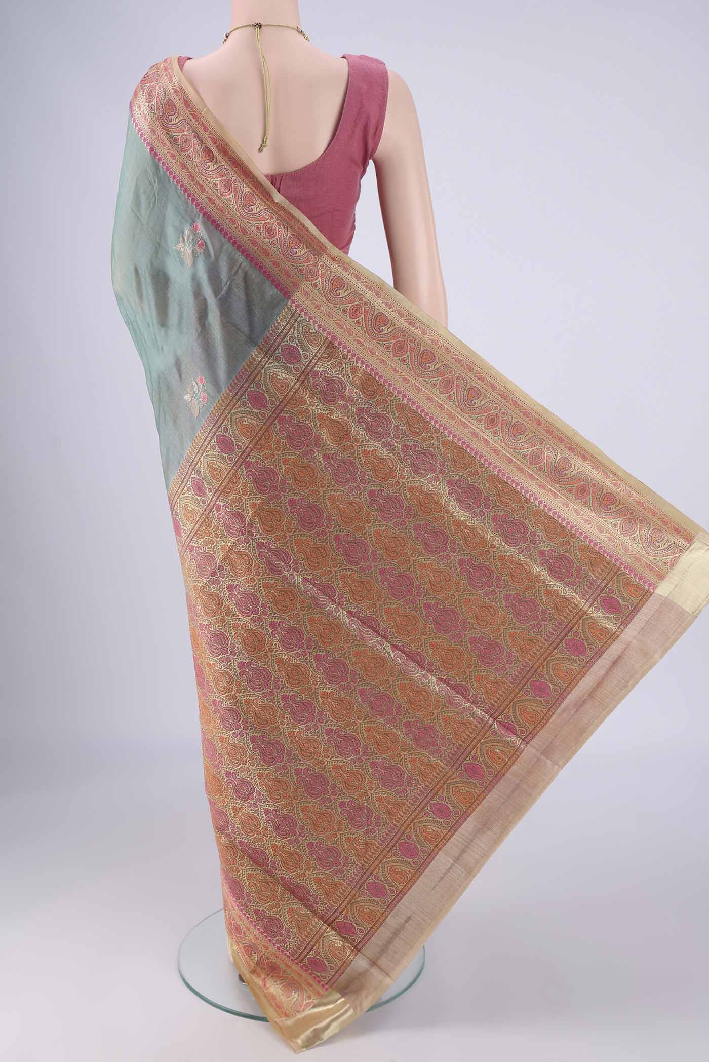 Flat view of Light Green Banarasi Tussar Silk Saree with Embroidery on the body and Zari Border. 