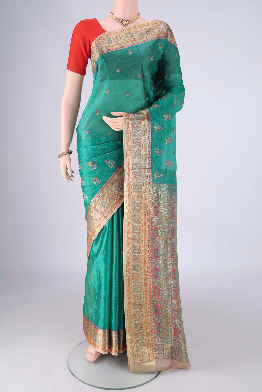 Sea Green Banarasi Tussar Silk Saree with Embroidery on the body and Zari Border.  displayed on a mannequin