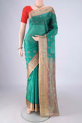 Sea Green Banarasi Tussar Silk Saree with Embroidery on the body and Zari Border.  displayed on a mannequin