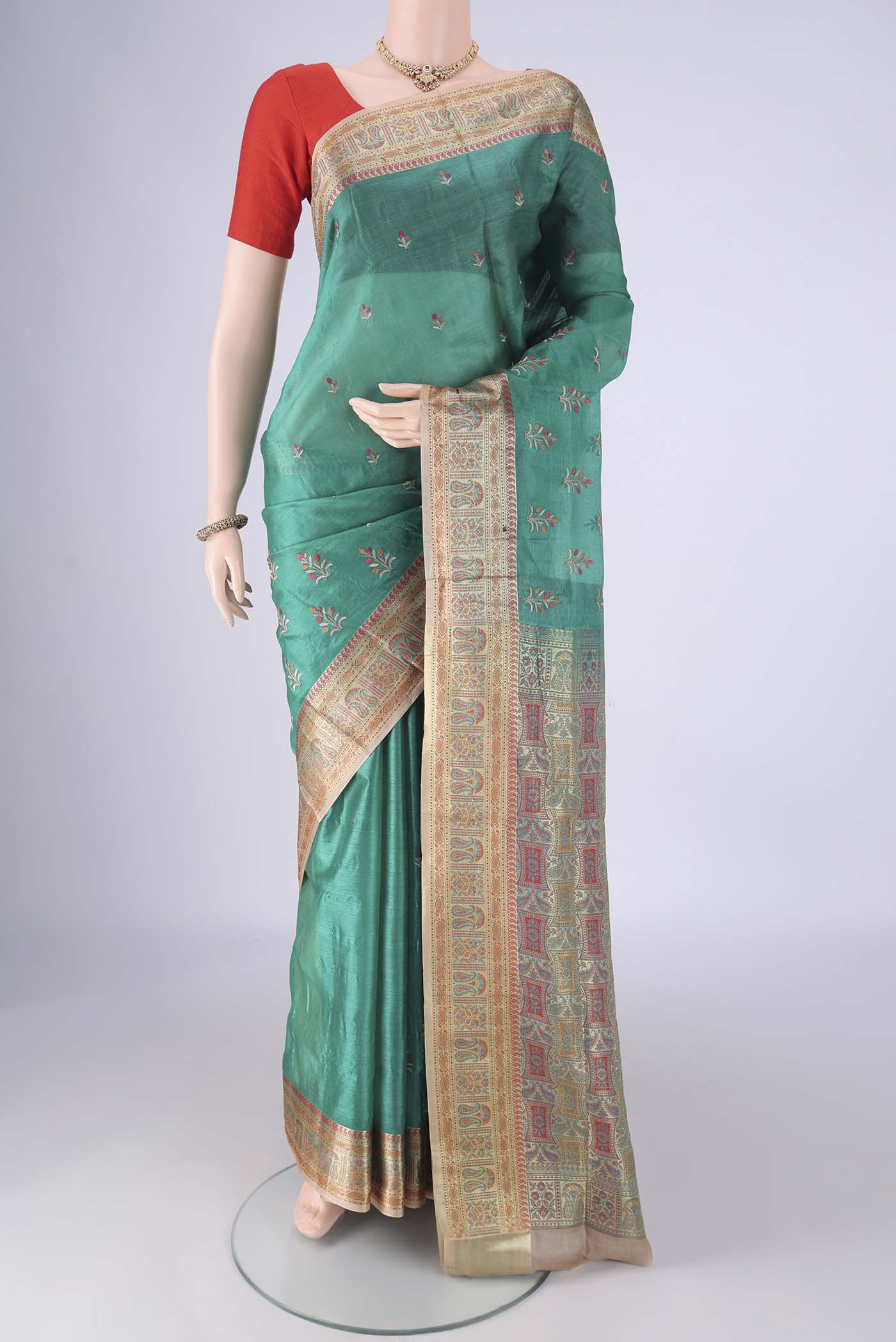 Sea Green Banarasi Tussar Silk Saree with Embroidery on the body and Zari Border.  displayed on a mannequin