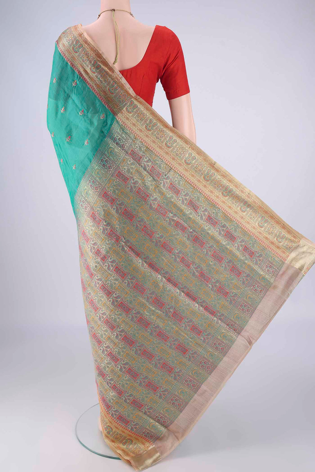 Flat view of Sea Green Banarasi Tussar Silk Saree with Embroidery on the body and Zari Border. 