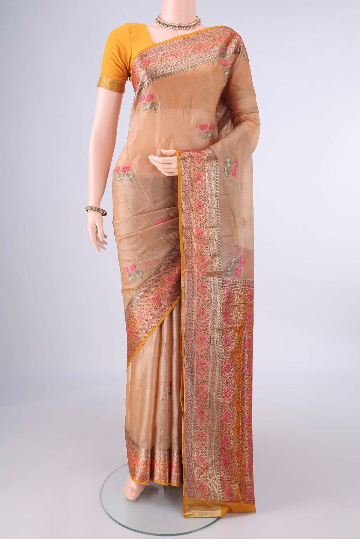 Sandal Banarasi Tussar Saree with Embroidery on the body and Zari Border.  displayed on a mannequin