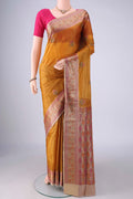 Mustard Banarasi Tussar Saree with Embroidery on the body and Zari Border.  displayed on a mannequin