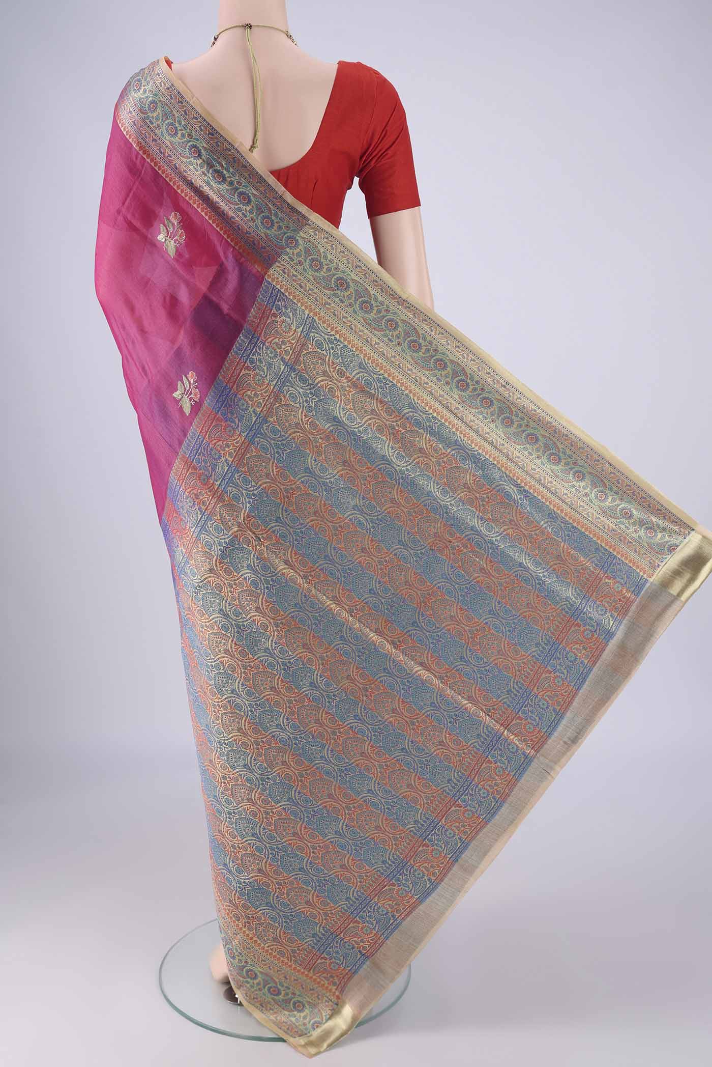 Flat view of Dark Pink Banarasi Tussar Silk Saree with Embroidery on the body and Zari Border. 