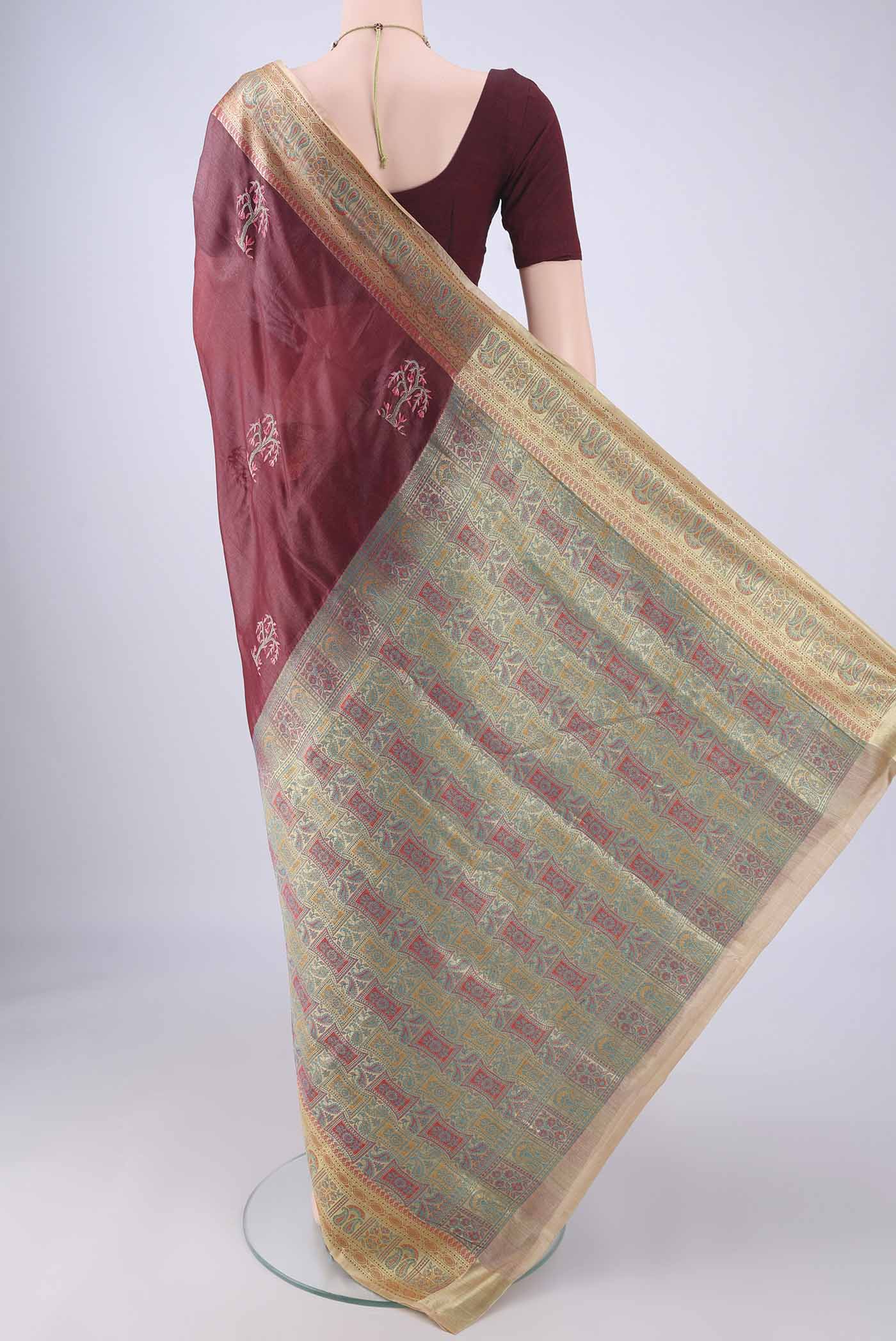 Flat view of Coffee Brown Banarasi Tussar Silk Saree with Embroidery on the body and Zari Border. 