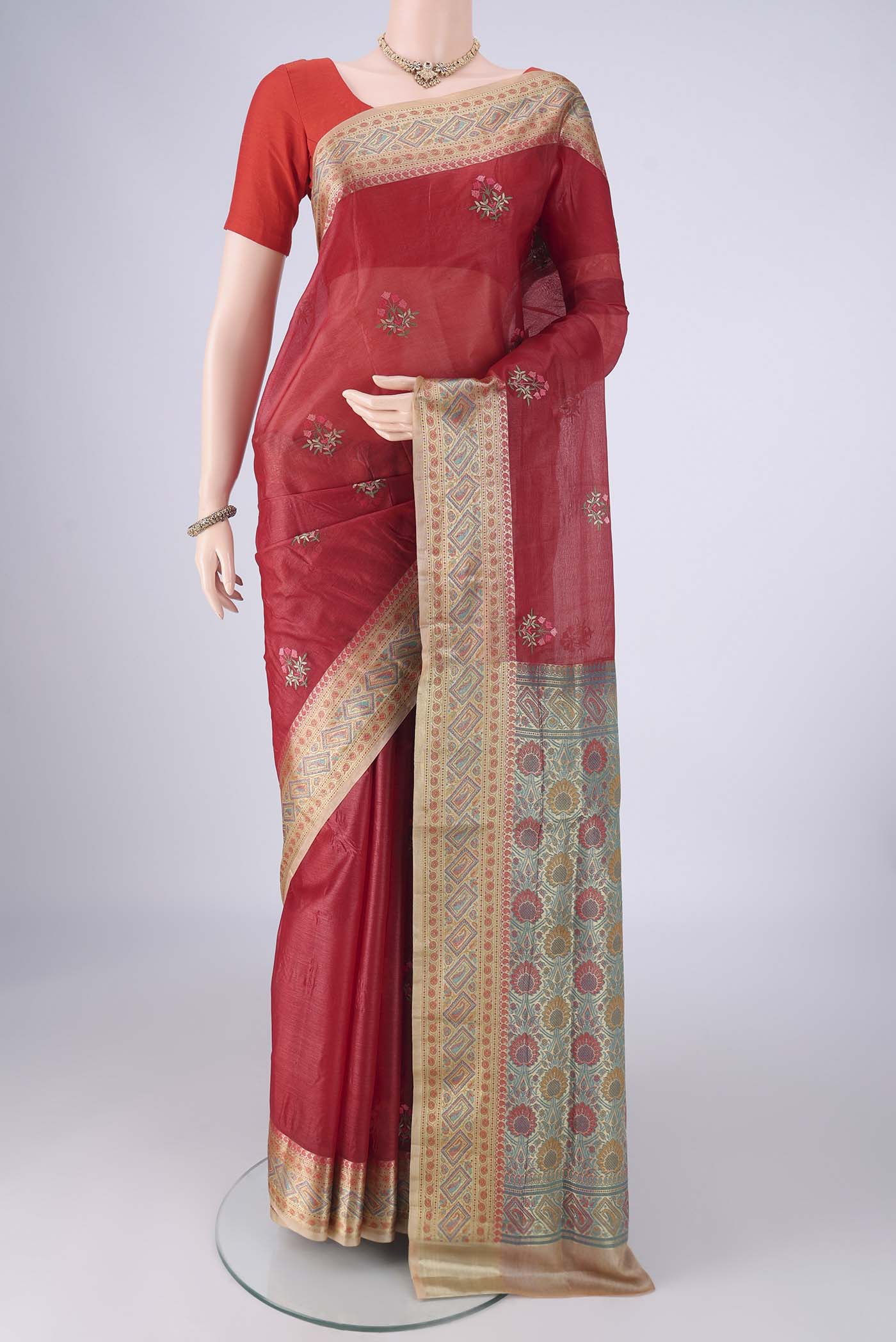 Red Banarasi Tussar Silk Saree with Embroidery on the body and Zari Border.  displayed on a mannequin