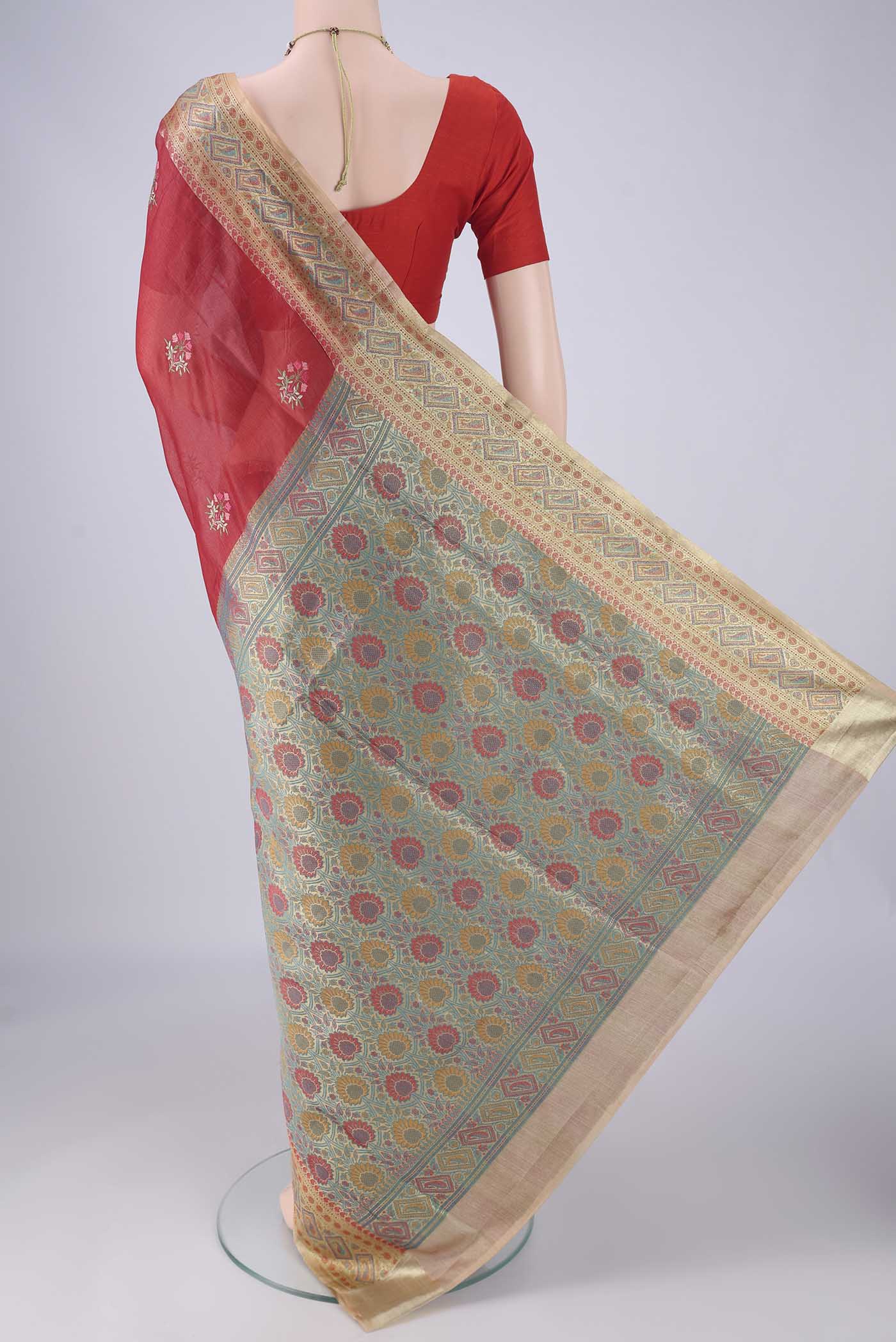 Flat view of Red Banarasi Tussar Silk Saree with Embroidery on the body and Zari Border. 