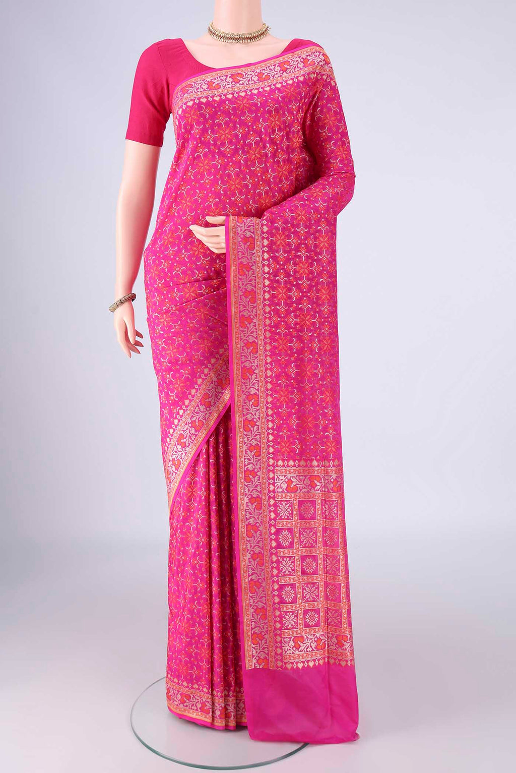 Rani Pink Banarasi Silk Saree with Zari And Thread Butta on the body and Zari And Thread Border.  displayed on a mannequin