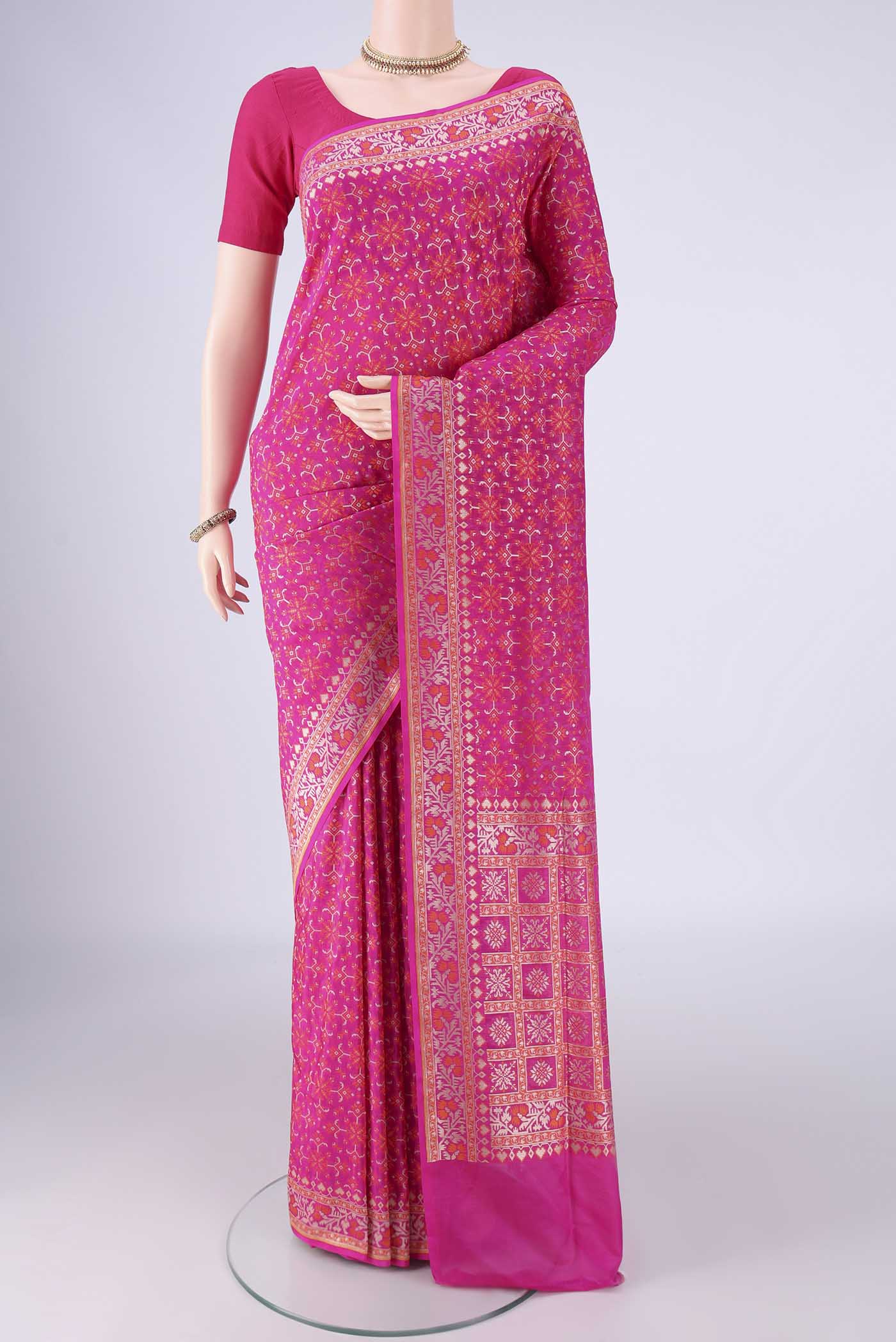 Rani Pink Banarasi Silk Saree with Zari And Thread Butta on the body and Zari And Thread Border.  displayed on a mannequin