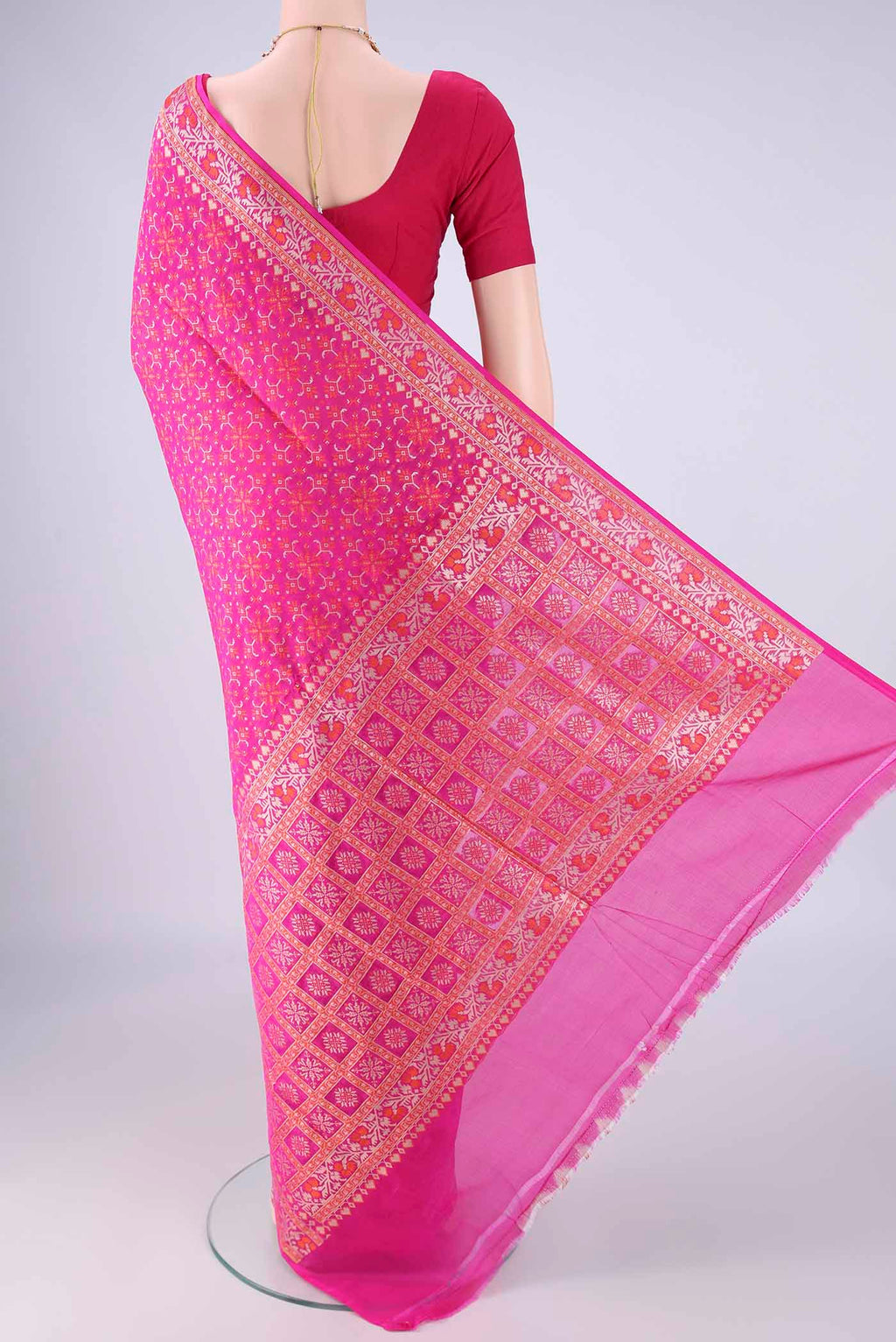 Flat view of Rani Pink Banarasi Silk Saree with Zari And Thread Butta on the body and Zari And Thread Border. 