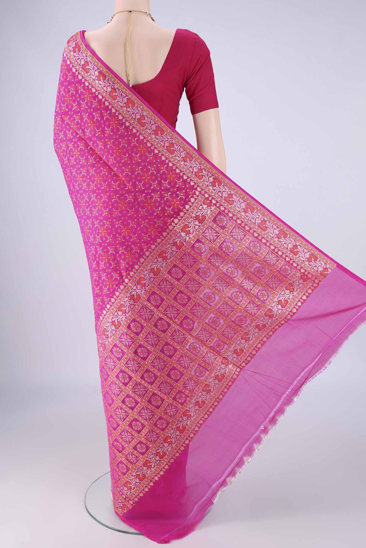 Flat view of Rani Pink Banarasi Silk Saree with Zari And Thread Butta on the body and Zari And Thread Border. 