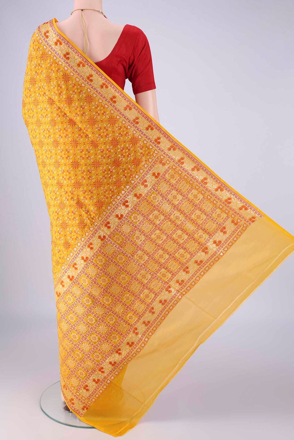 Flat view of Yellow Banarasi Silk Saree with Zari And Thread Butta on the body and Zari And Thread Border. 