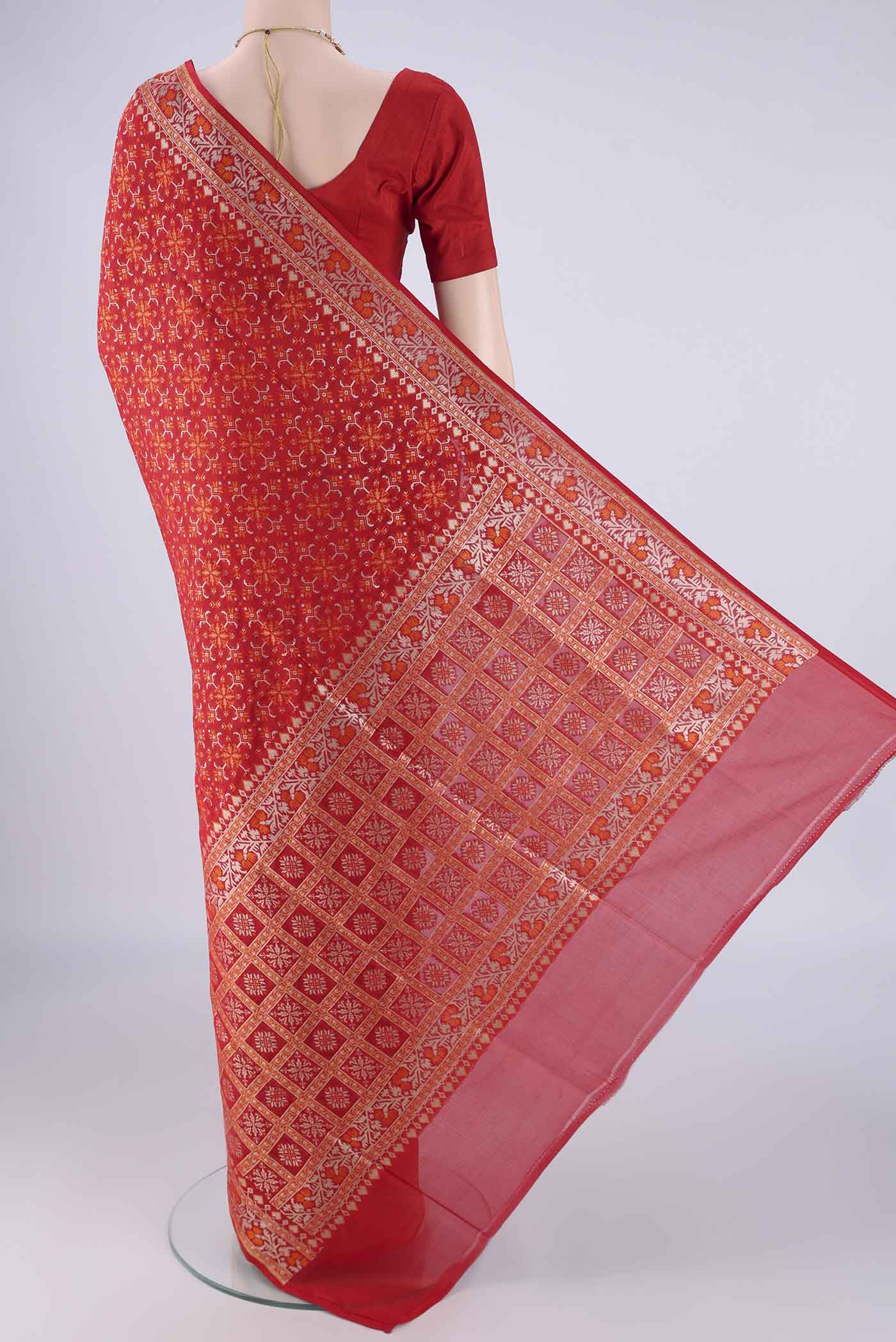 Flat view of Red Banarasi Silk Saree with Zari And Thread Butta on the body and Zari And Thread Border. 