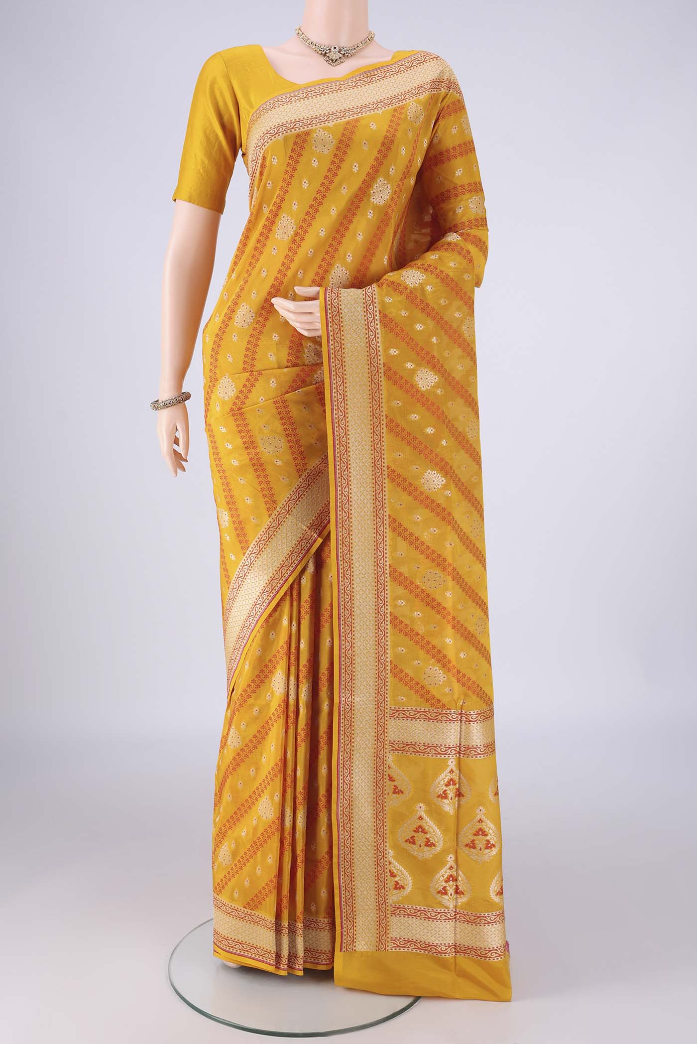 Yellow Banarasi Silk Saree with Zari And Thread Butta on the body and Zari Border.  displayed on a mannequin