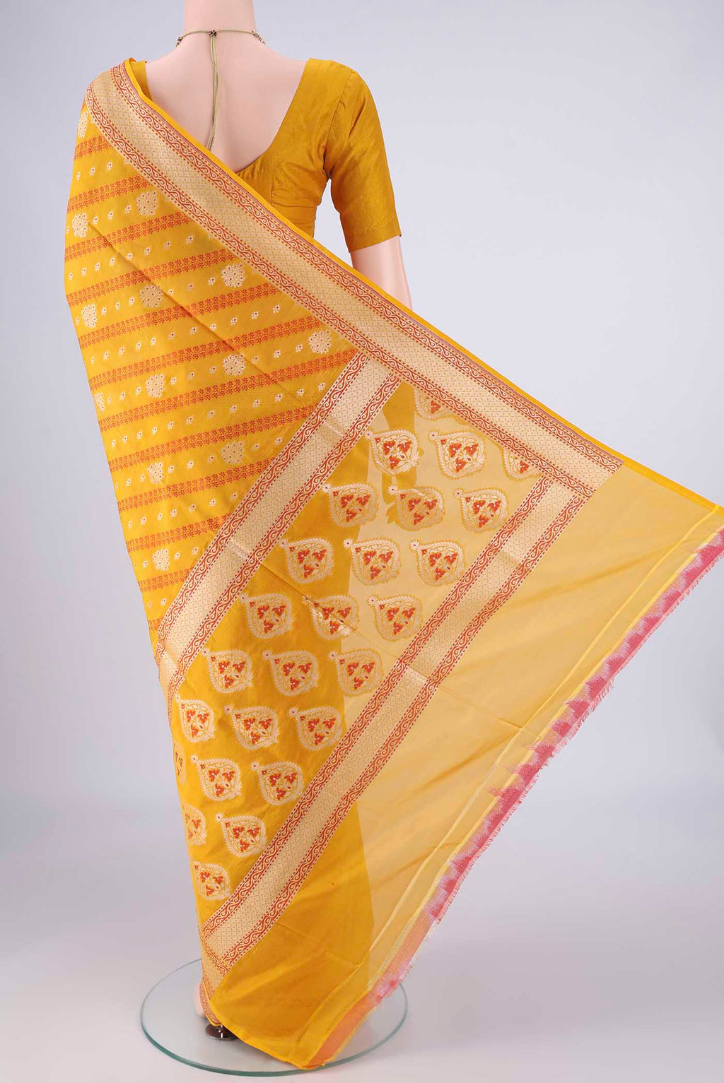Flat view of Yellow Banarasi Silk Saree with Zari And Thread Butta on the body and Zari Border. 
