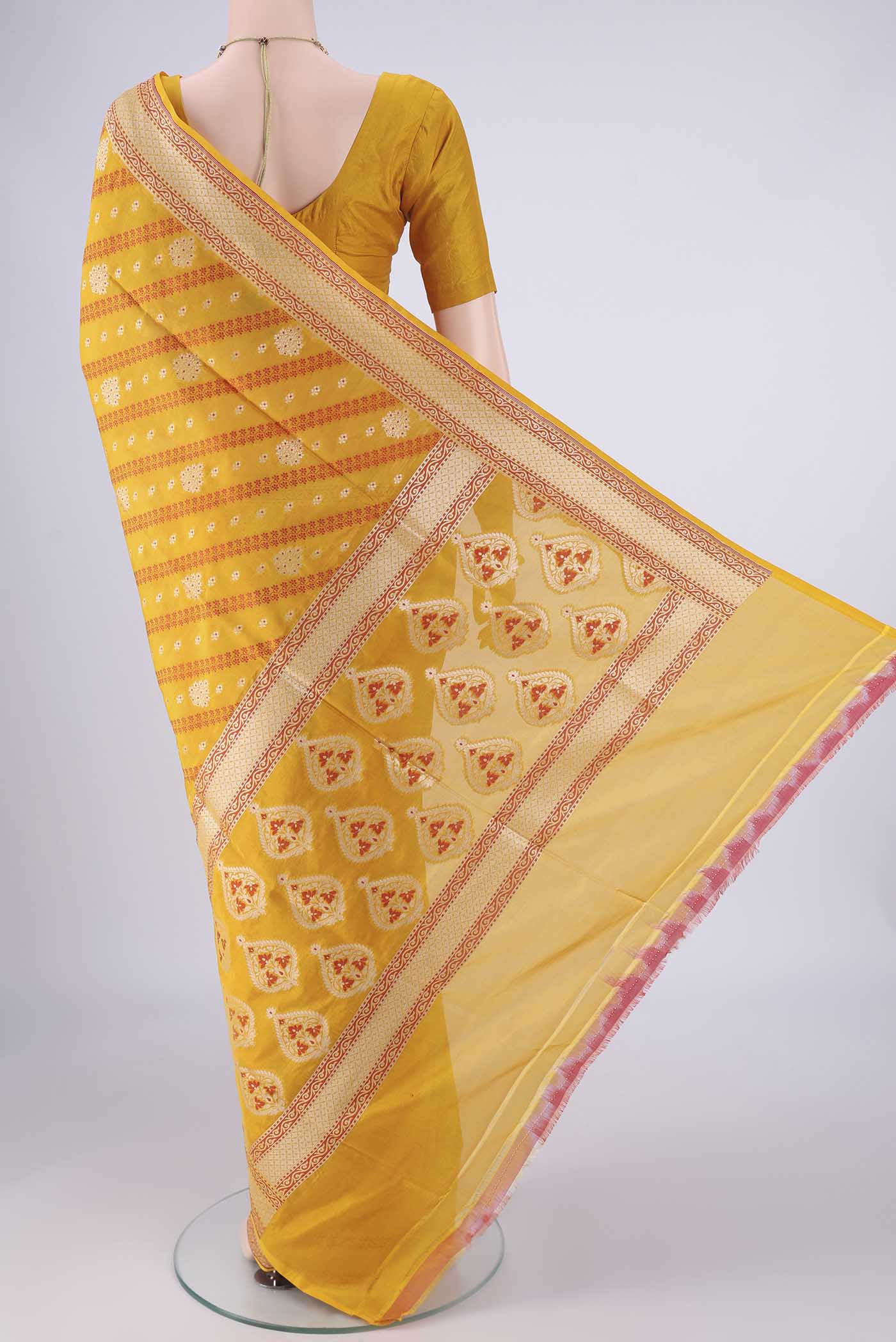 Flat view of Yellow Banarasi Silk Saree with Zari And Thread Butta on the body and Zari Border. 