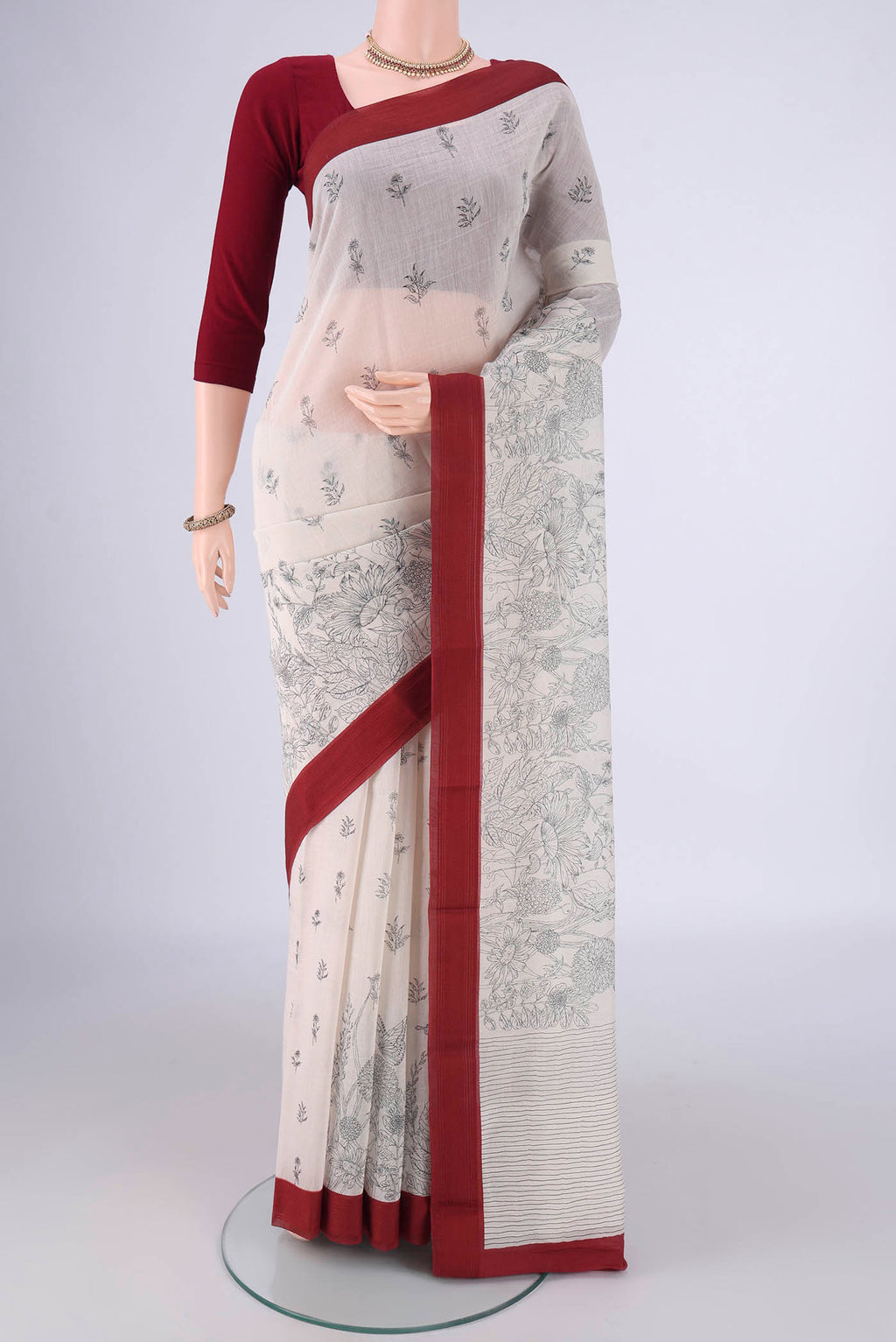 Off White Chanderi Silk Cotton Saree with Printed design on the body and Thread Border.  displayed on a mannequin