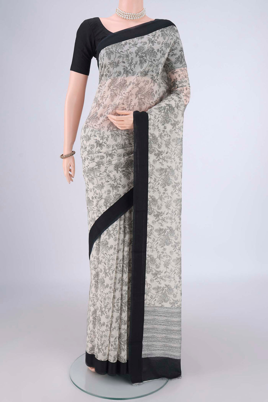 Off White Chanderi Silk Cotton Saree with Printed design on the body and Thread Border.  displayed on a mannequin
