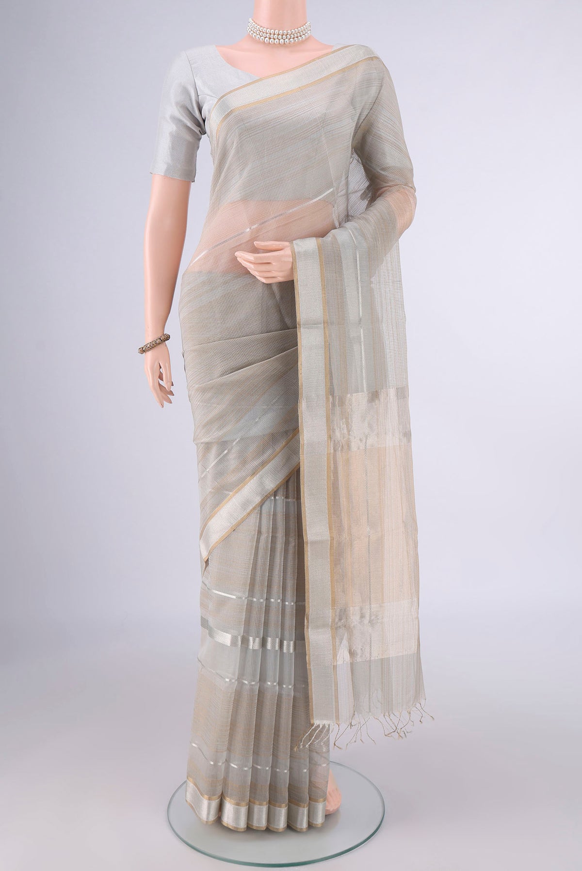 Grey Maheshwari Cotton Saree with Stripes on the body and Plain Border.  displayed on a mannequin
