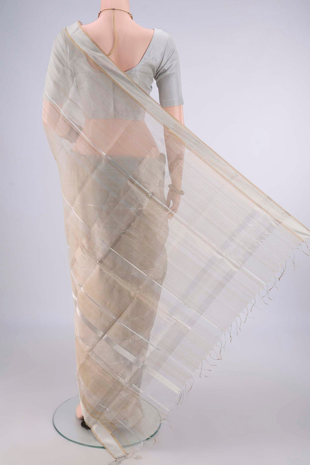 Flat view of Grey Maheshwari Cotton Saree with Stripes on the body and Plain Border. 