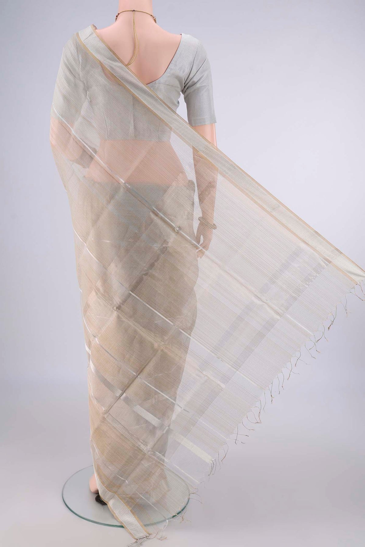 Flat view of Grey Maheshwari Cotton Saree with Stripes on the body and Plain Border. 