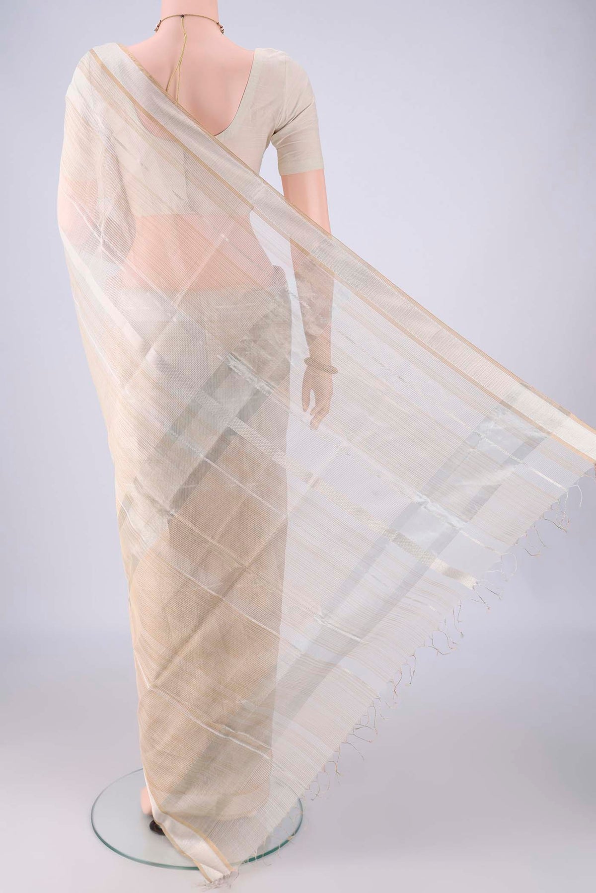 Flat view of Off White Maheshwari Silk Cotton Saree with Stripes on the body and Zari Border. 