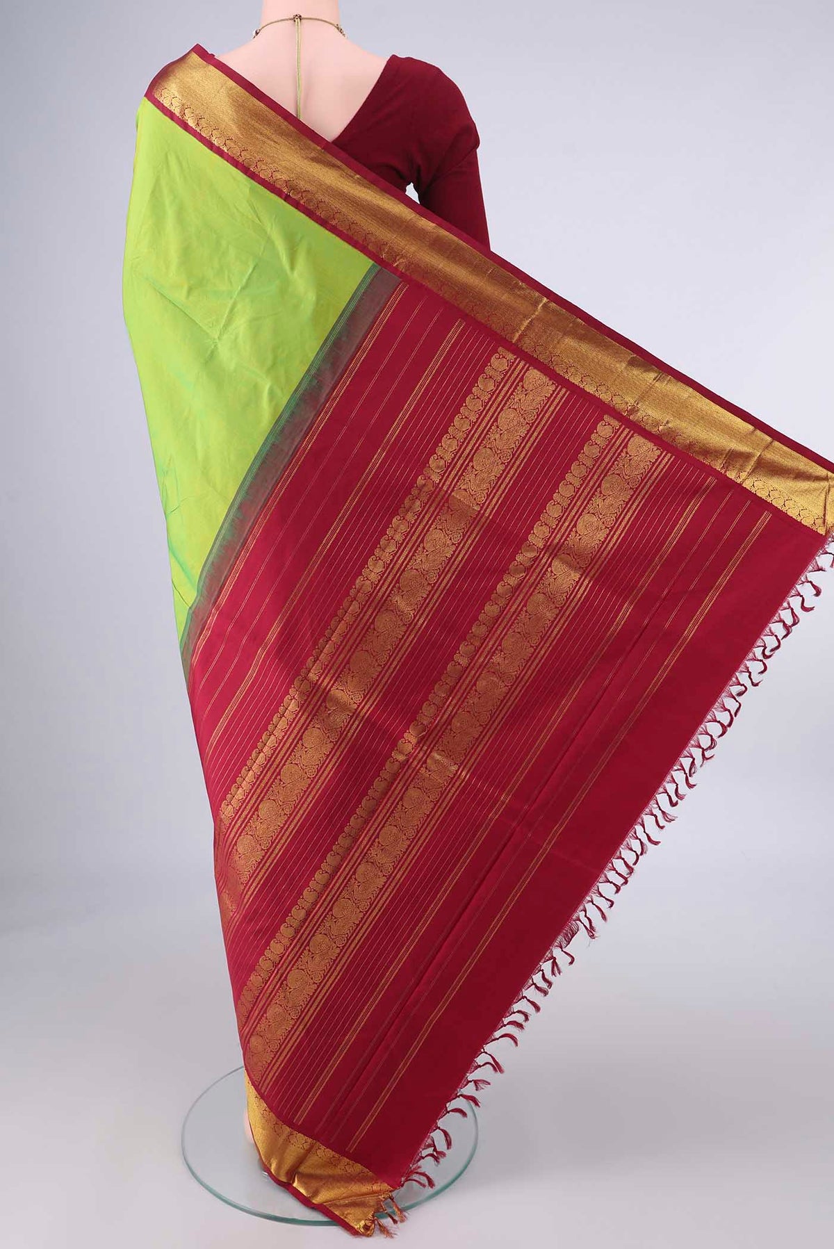 Flat view of Pure Silk Parrot Green Kanjivaram Saree with Plain Body and Zari Border. 